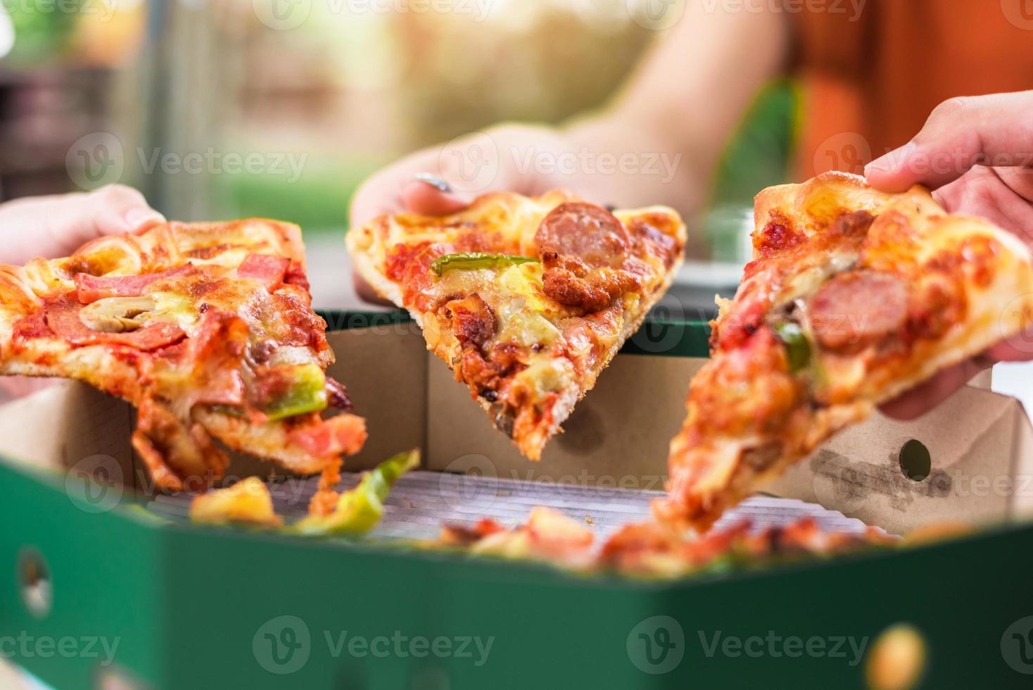 mensen handen nemen plakjes pizza margherita foto