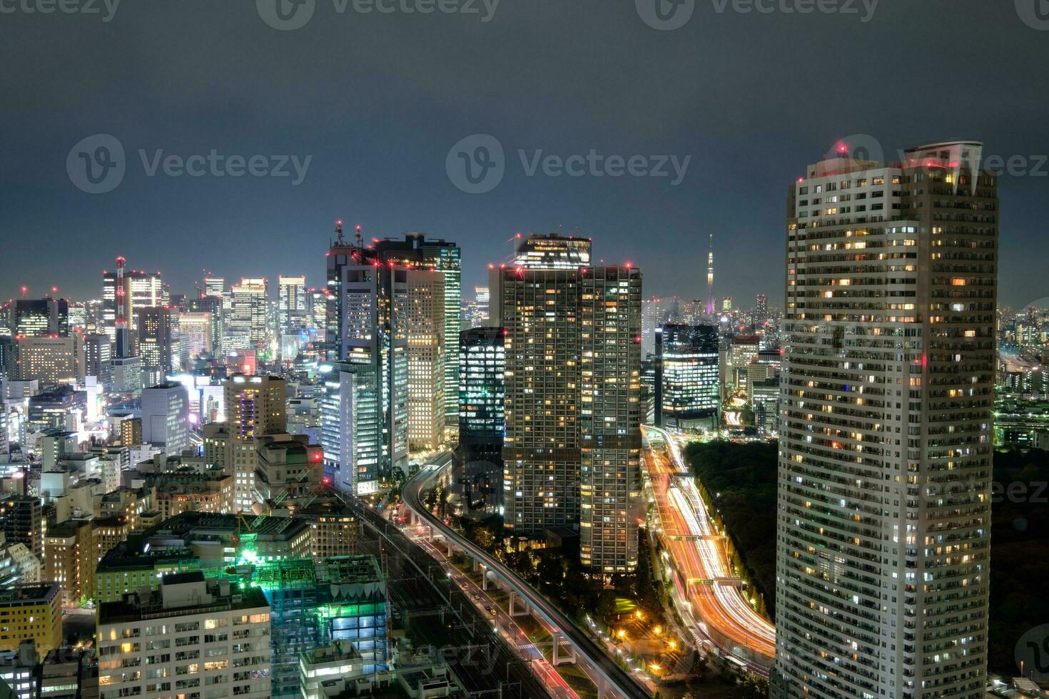 visie van wolkenkrabber en gloeiend licht verkeer in downtown Bij nacht foto