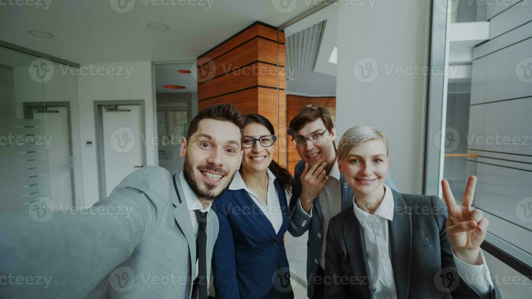 pov van gelukkig bedrijf team nemen selfie portret Aan smartphone camera en poseren voor groep foto gedurende vergadering in modern kantoor binnenshuis