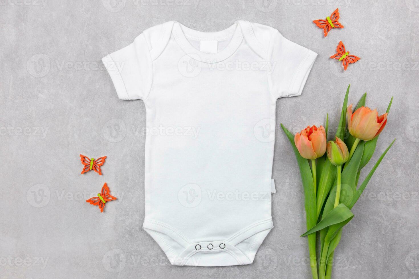 wit baby meisje of jongen bodysuit mockup vlak leggen met oranje tulpen bloemen en vlinders decoratie Aan de grijs beton achtergrond. ontwerp Onesie sjabloon, afdrukken presentatie bespotten omhoog. top visie. foto