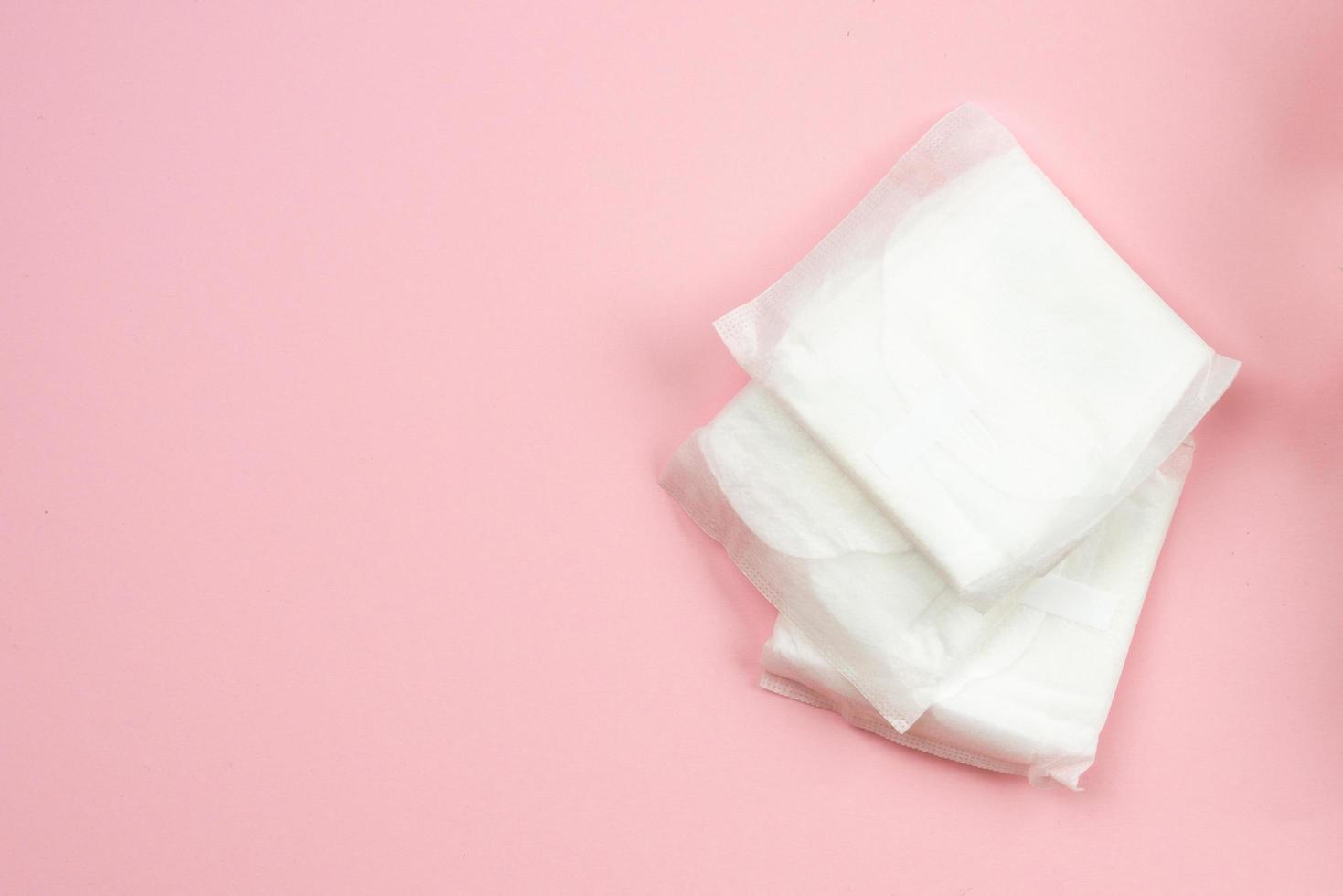 vrouw pads liggend op roze achtergrond. vrouw hygiëne bescherming sanitair foto