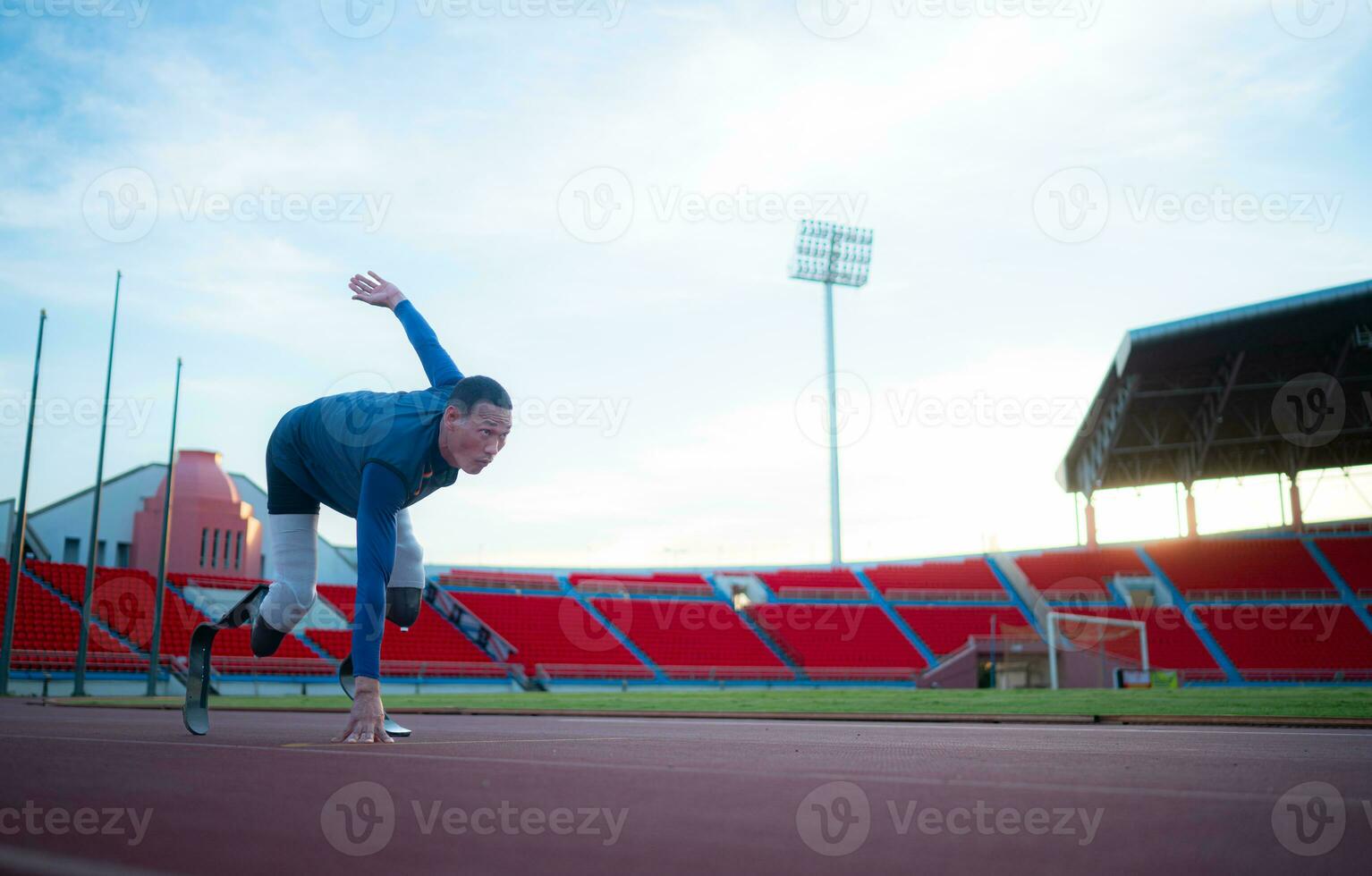 gehandicapt atleten bereiden in beginnend positie klaar naar rennen Aan stadion bijhouden foto