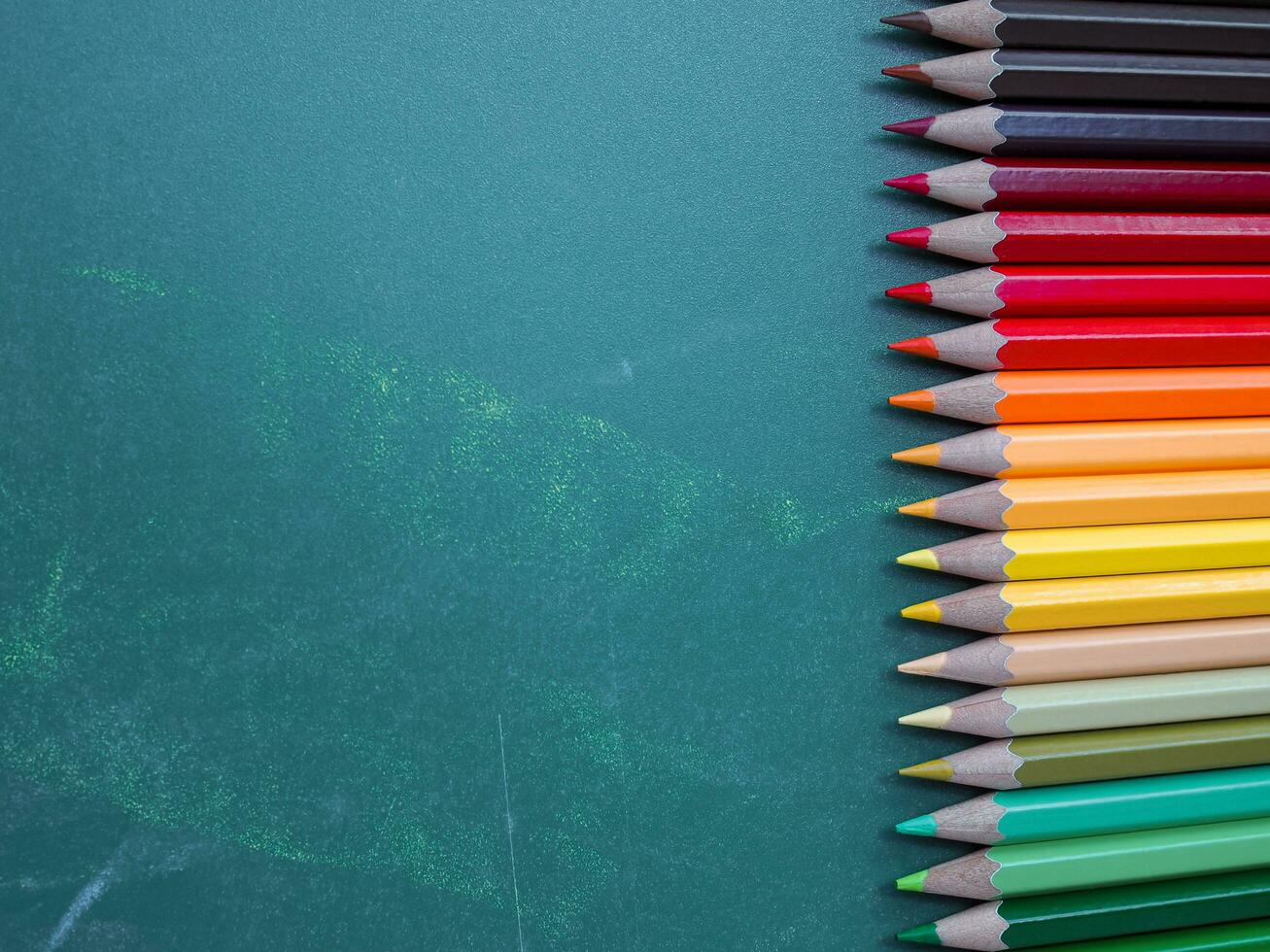 kleur potloden Aan schoolbord achtergrond foto