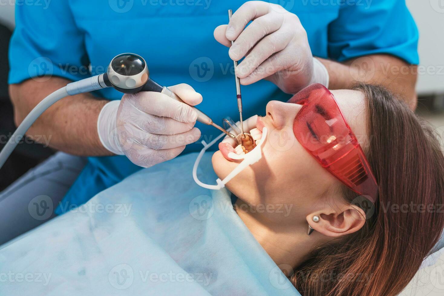 dokter orthodontist presteert een procedure voor schoonmaak tanden foto