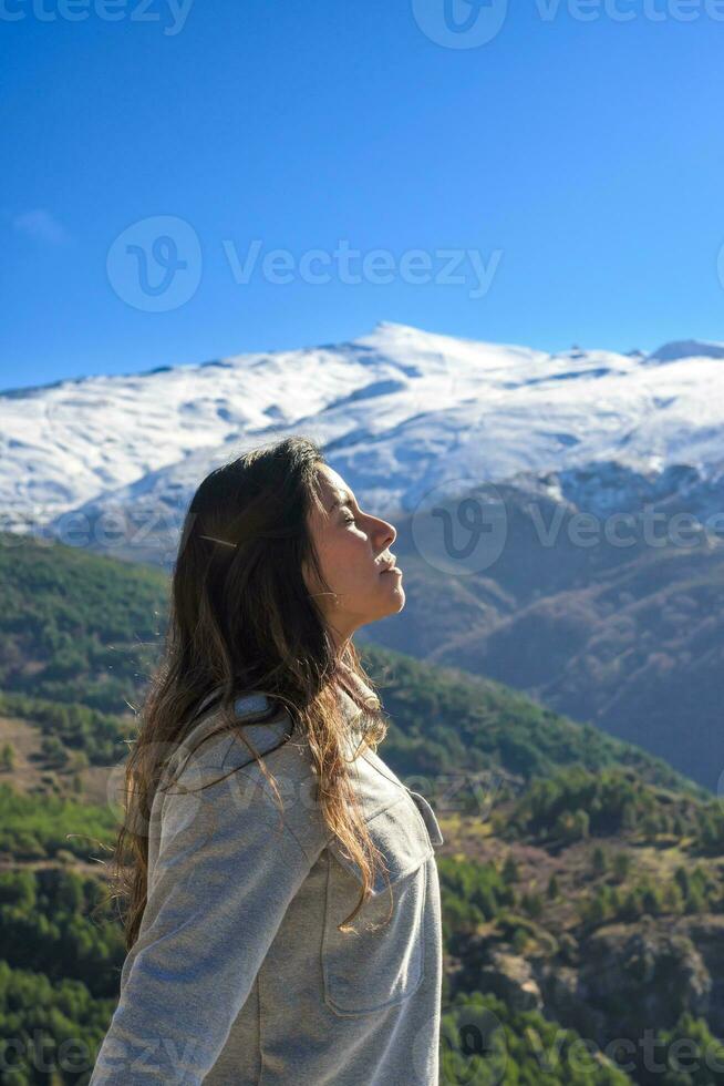 latina vrouw, lang haar, ademhaling vers lucht Bij de top van de berg, sierra Nevada Spanje foto