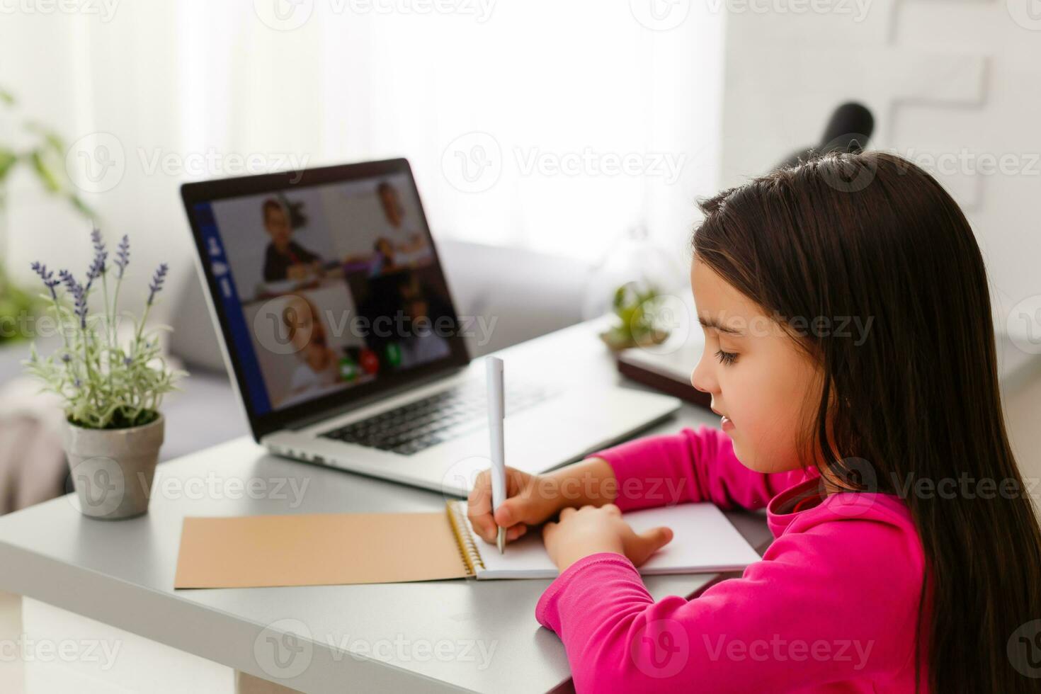 weinig meisje aan het studeren met computer foto