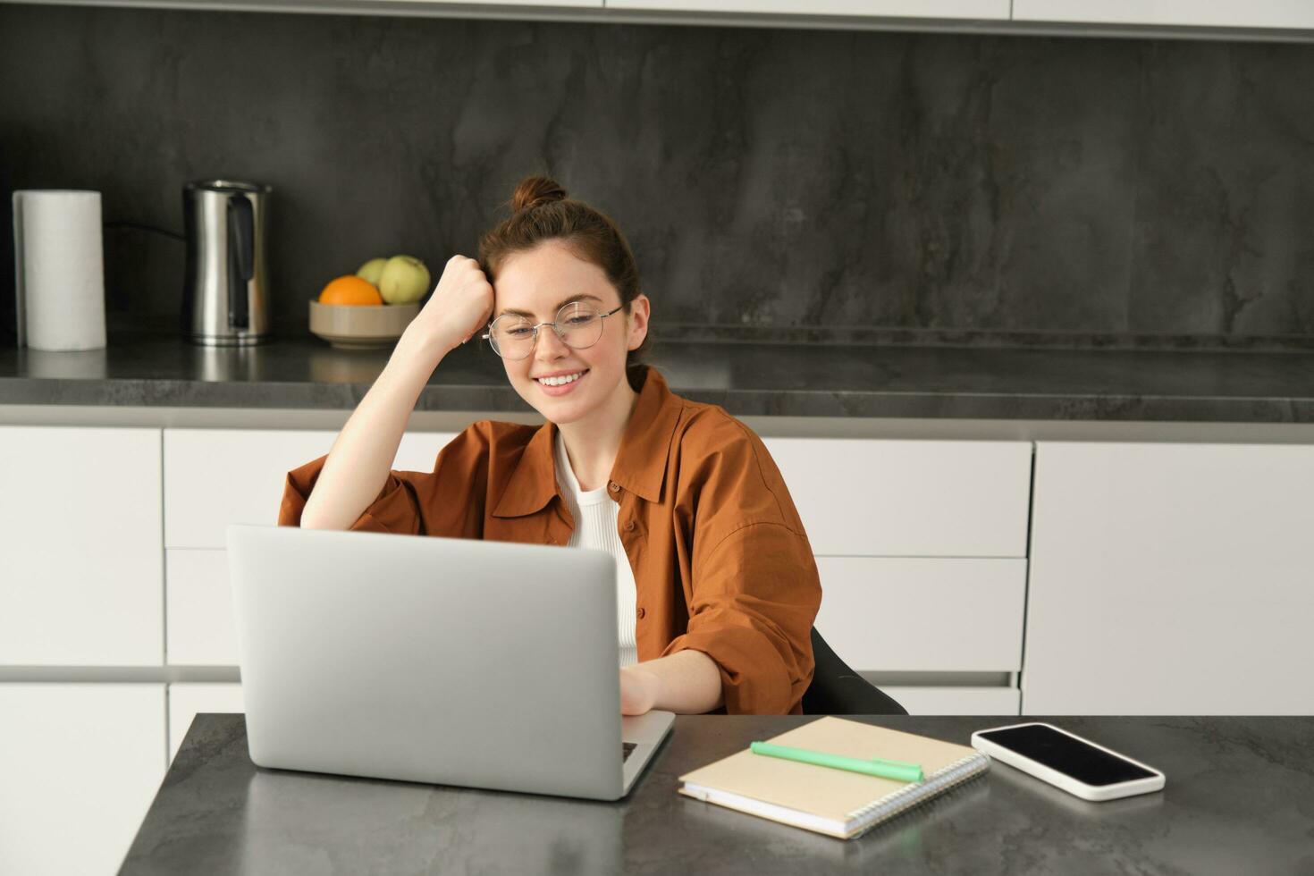 portret van vrouw freelancer, programmeur werken van huis. vrouw leerling of bedrijf eigenaar zittend met laptop in keuken foto