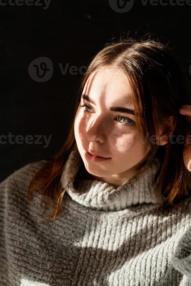 portret van een mooie jonge vrouw in een strohoed met een schaduwpatroon op het gezicht en lichaam foto