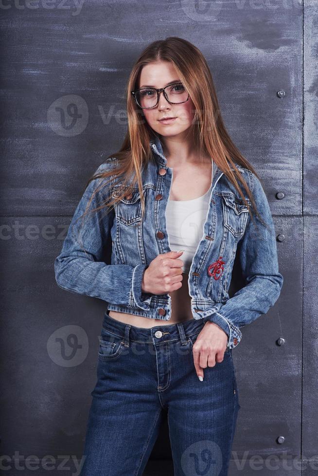 mode, kleding, mensen concept. aantrekkelijke sexy jonge vrouw met jeans jasje. meisje poseert in de studio foto