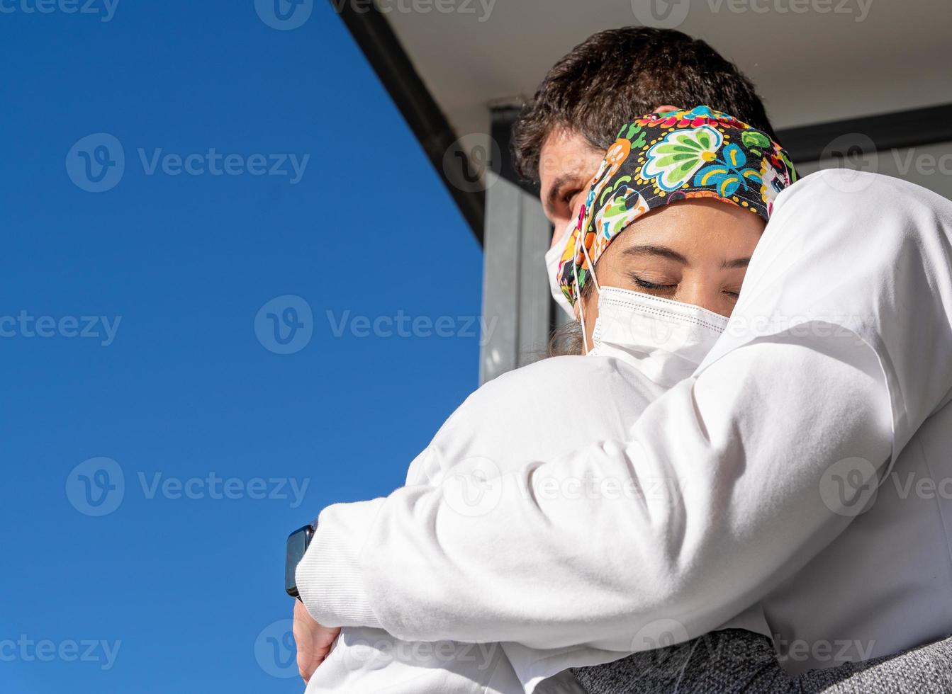 dokters met maskers die elkaar omhelzen foto