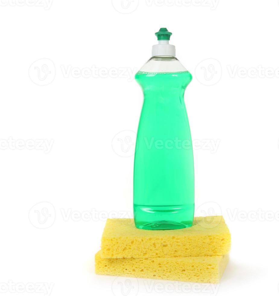 afwasmiddel in een flesje met 2 gele sponzen foto