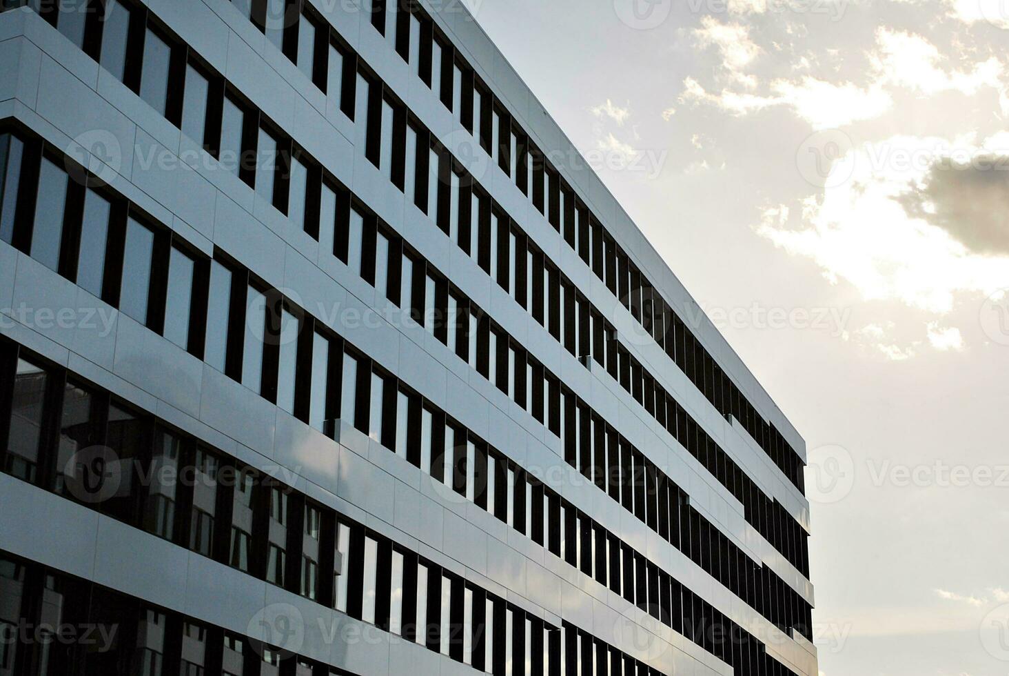 abstract detailopname van de glas bekleed facade van een modern gebouw gedekt in reflecterende bord glas. architectuur abstract achtergrond. glas muur en facade detail. foto