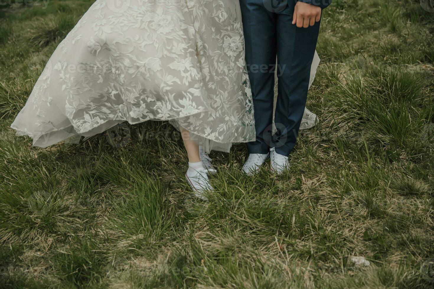 gelukkig bruiloft paar in de bergen. schoenen Bij een bruiloft. gemakkelijk stijl. bruiloft jurk en sportschoenen. bruiloft foto sessie in natuur. foto sessie in de Woud van de bruid en bruidegom.