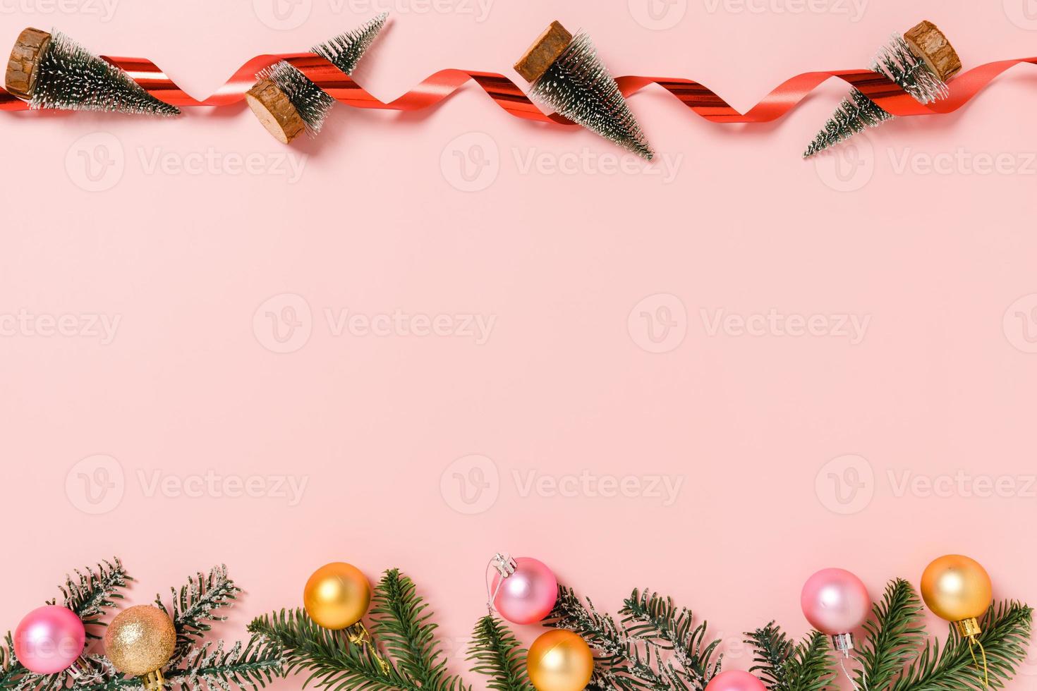 minimale creatieve platte lay van traditionele kerstcompositie en nieuwjaarsvakantieseizoen. bovenaanzicht winter kerstversiering op roze achtergrond met lege ruimte voor tekst. kopieer ruimtefotografie. foto