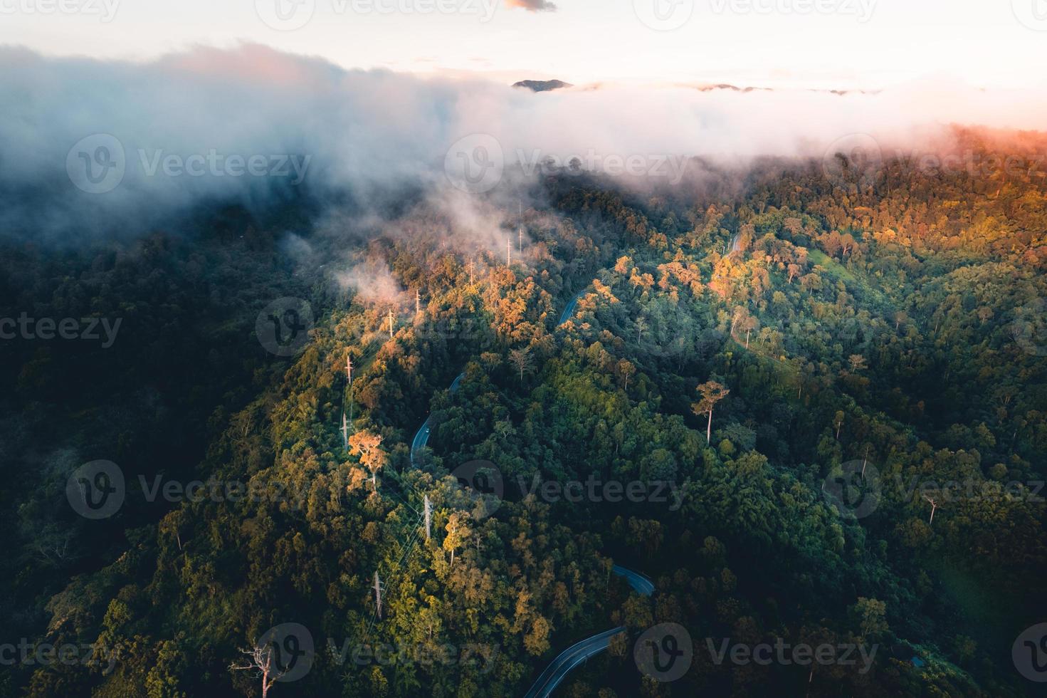 de zon komt op in de mist en de bergen in de ochtend foto