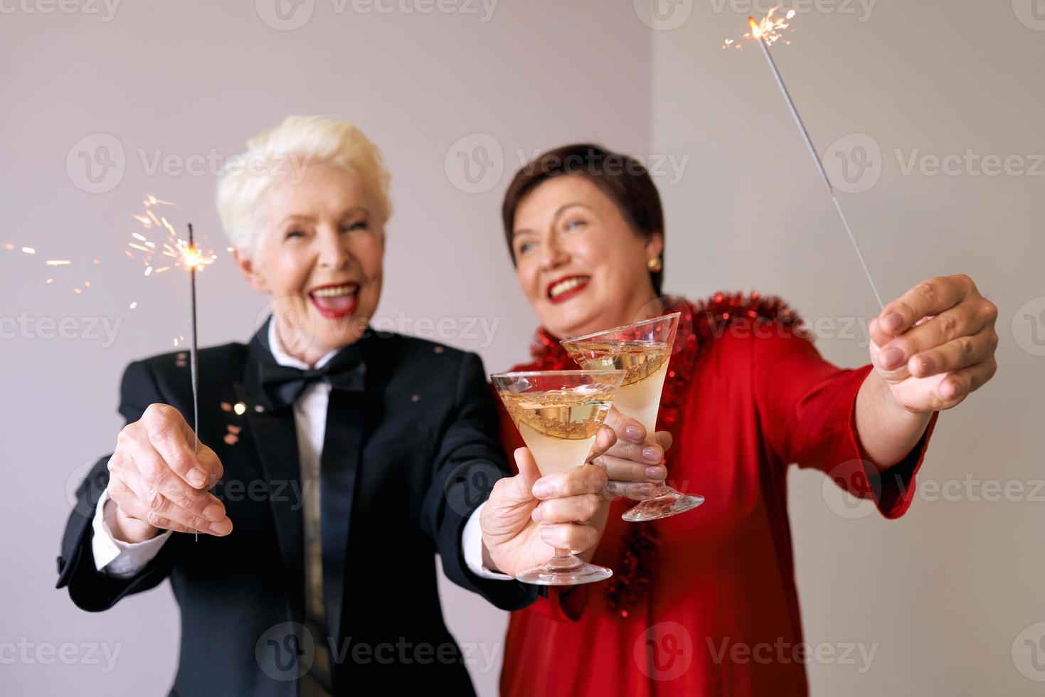 twee mooie stijlvolle volwassen senior vrouwen die nieuwjaar vieren. plezier, feest, stijl, feestconcept foto