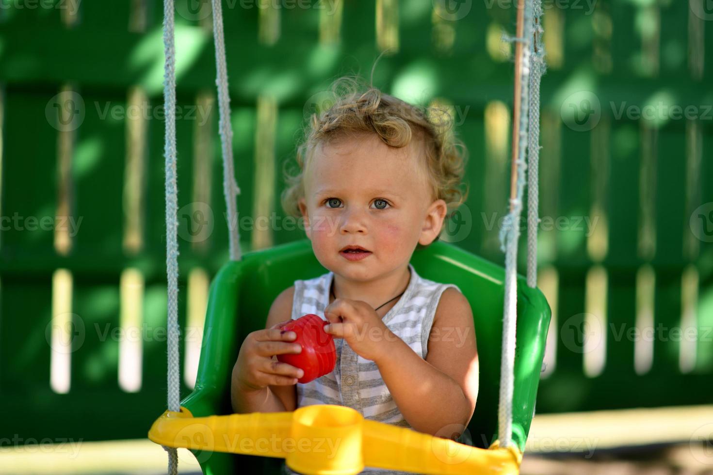 mooie babyjongen met kindschommel poseren fotograaf foto