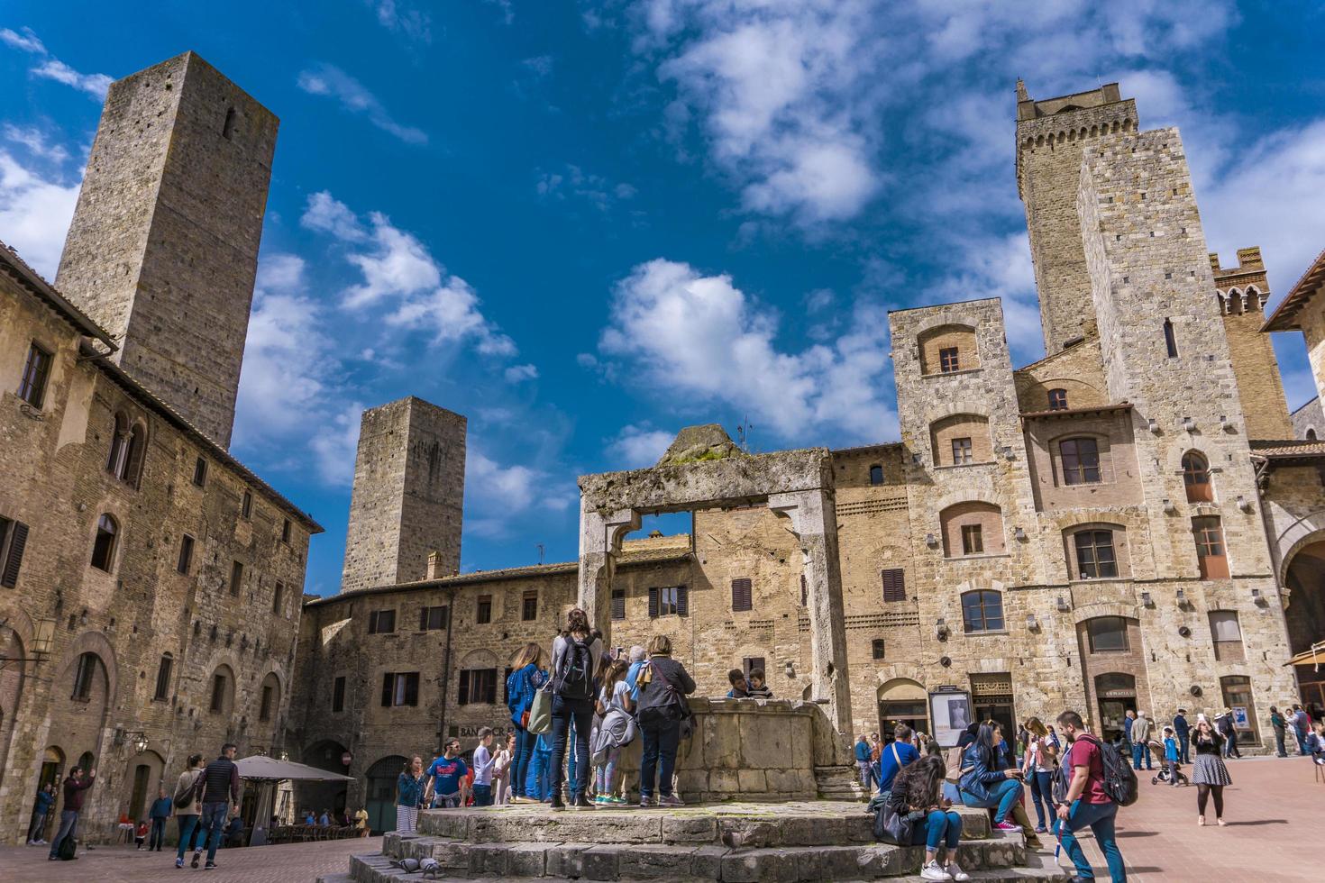 San Gimignano, Italië, 8 april 2018 - niet-geïdentificeerde mensen op Piazza della Cisterna in San Gimignano, Italië. historisch centrum van San Gimignano is sinds 1990 aangewezen als UNESCO-werelderfgoed. foto