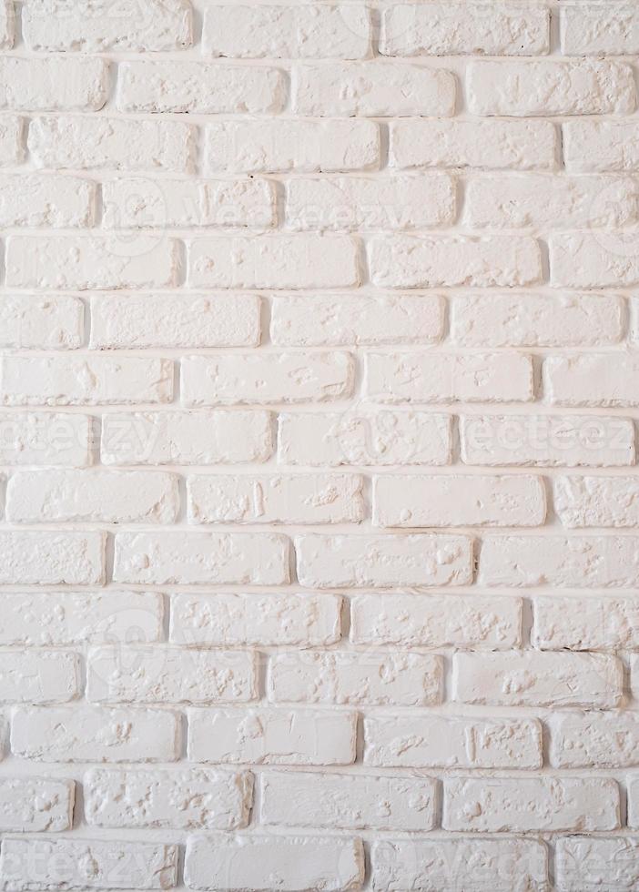 een witte bakstenen muur achtergrond verticale oriëntatie foto