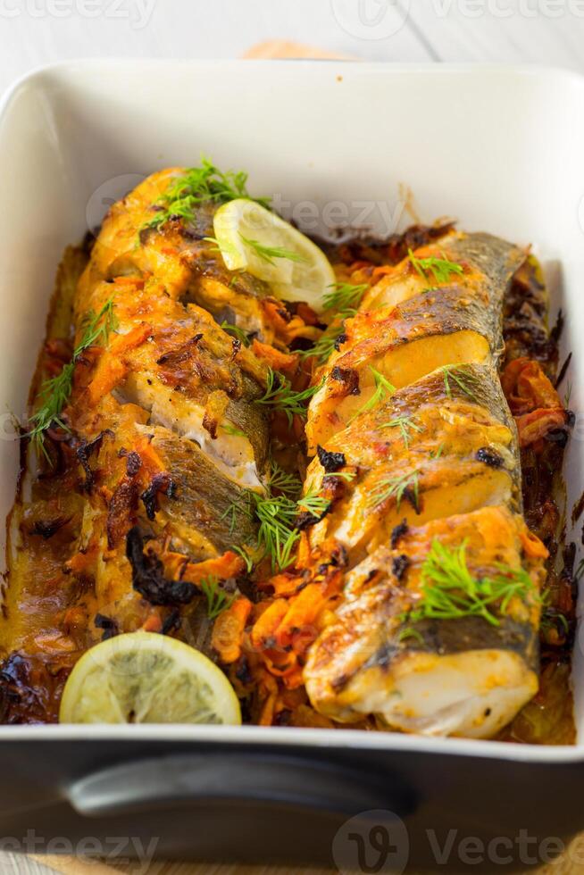 vis gebakken met specerijen en groenten in de oven. foto