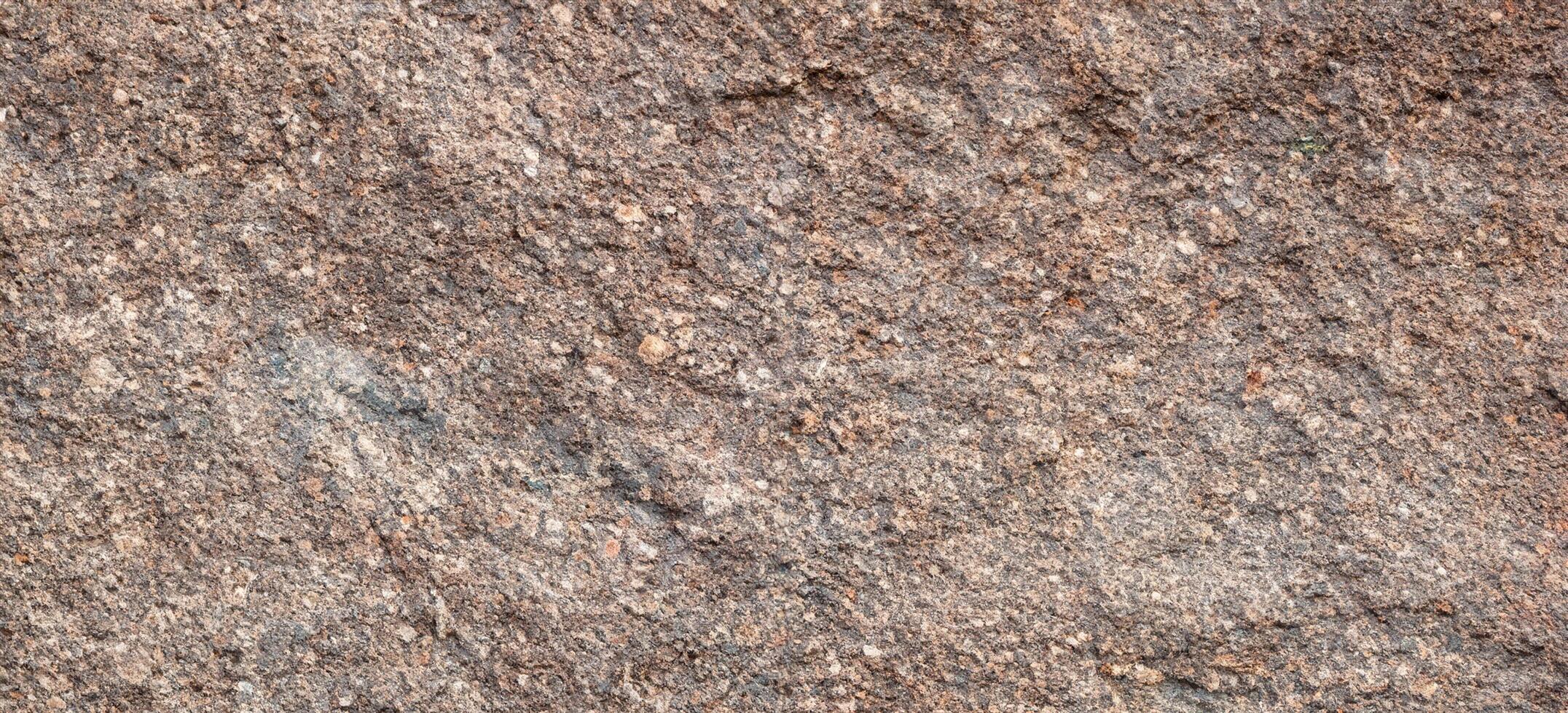 structuur van ruw graniet steen oppervlakte achtergrond foto