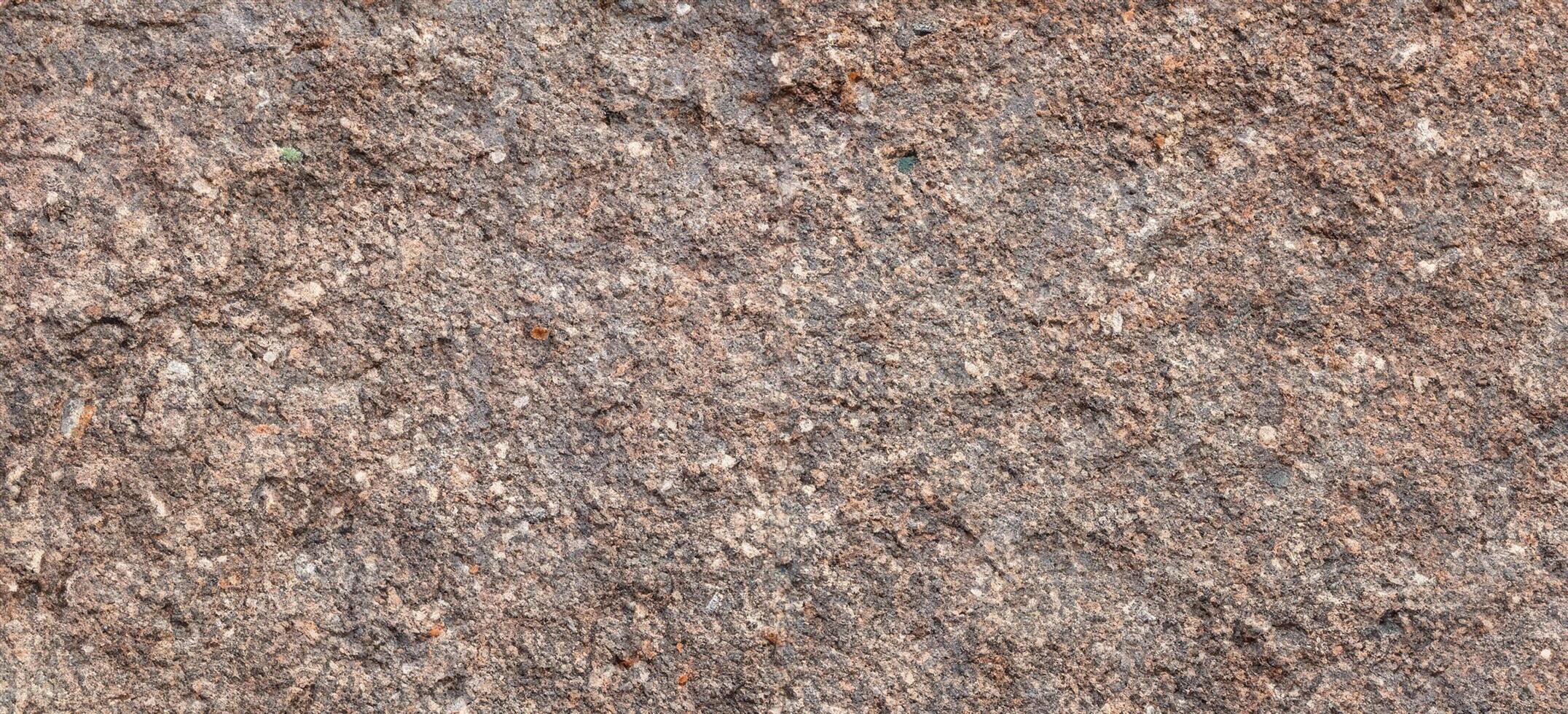 structuur van ruw graniet steen oppervlakte achtergrond foto