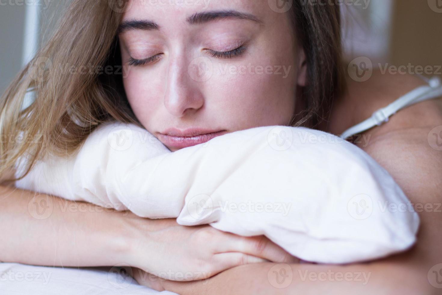 slapend meisje knuffelt kussen close-up portret selectieve aandacht foto