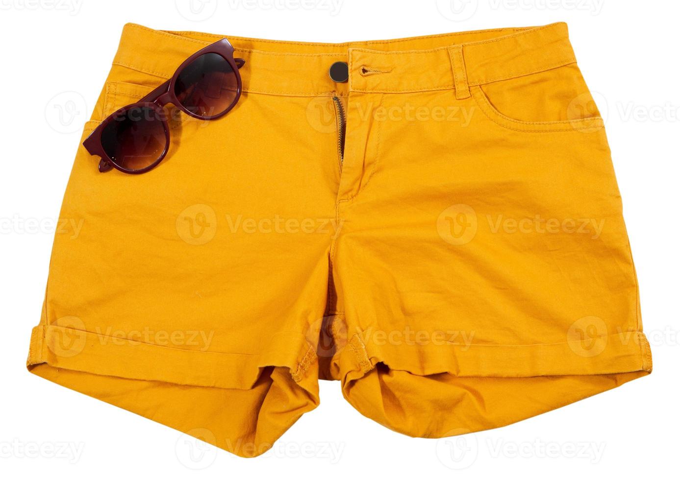 oranje korte broek en zonnebril geïsoleerd op een witte achtergrond foto