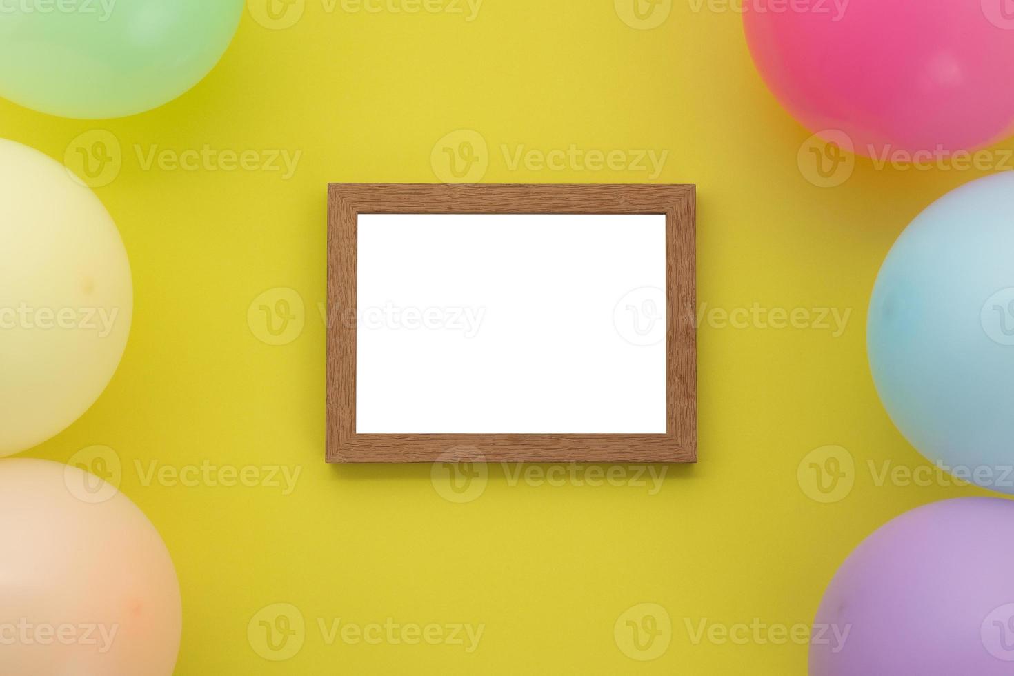 gelukkige verjaardagsachtergrond, plat liggende kleurrijke feestdecoratie met fotolijst op pastelgele achtergrond foto