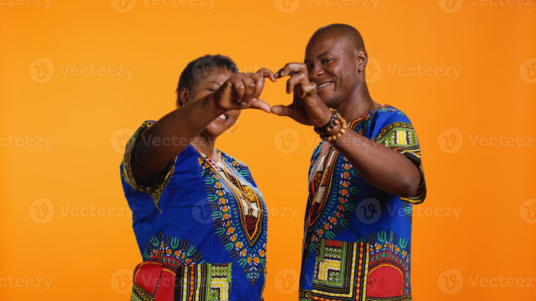 Afrikaanse Amerikaans paar aan het doen hart vormig teken met hun handen, uitdrukken waar liefde en oprecht zoet gevoelens. jong Mens en vrouw liefhebbend elk andere en presenteren romance symbool. foto