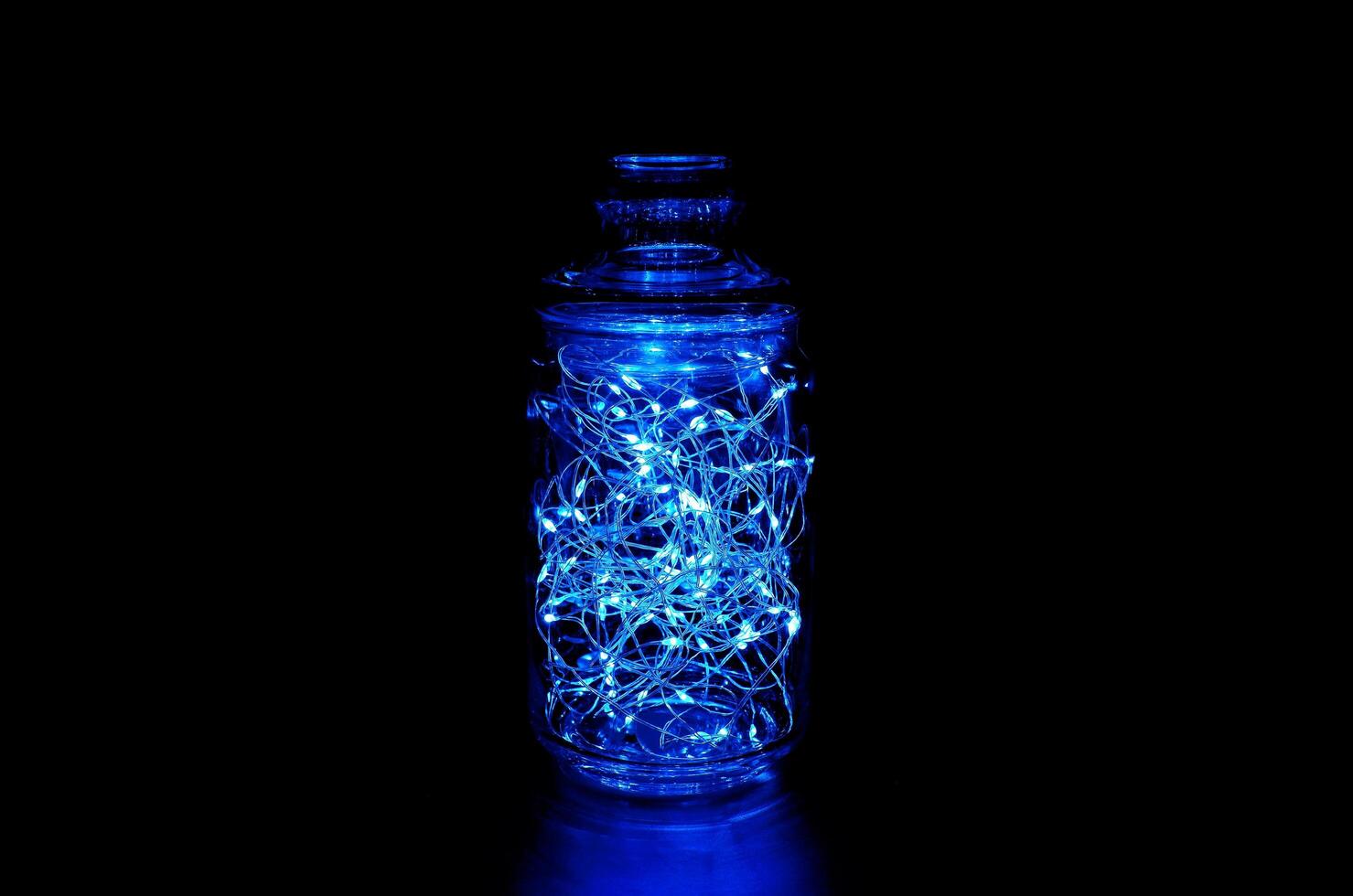 blauw fee licht in een glas kan, in de donker, rustig fotografie foto