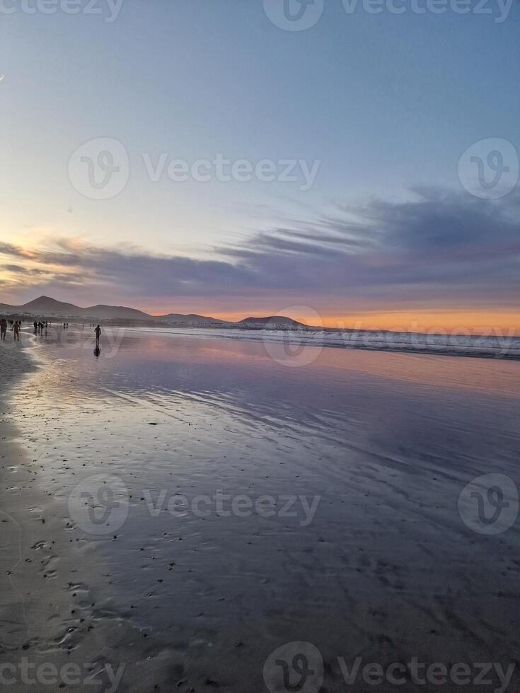 zonsondergang Aan famara strand Aan Lanzarote eiland foto