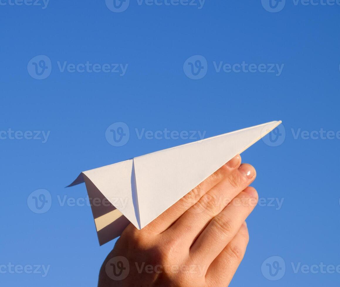 wit papier vliegtuig in hand- tegen de lucht. een symbool van vrijheid Aan de internet foto