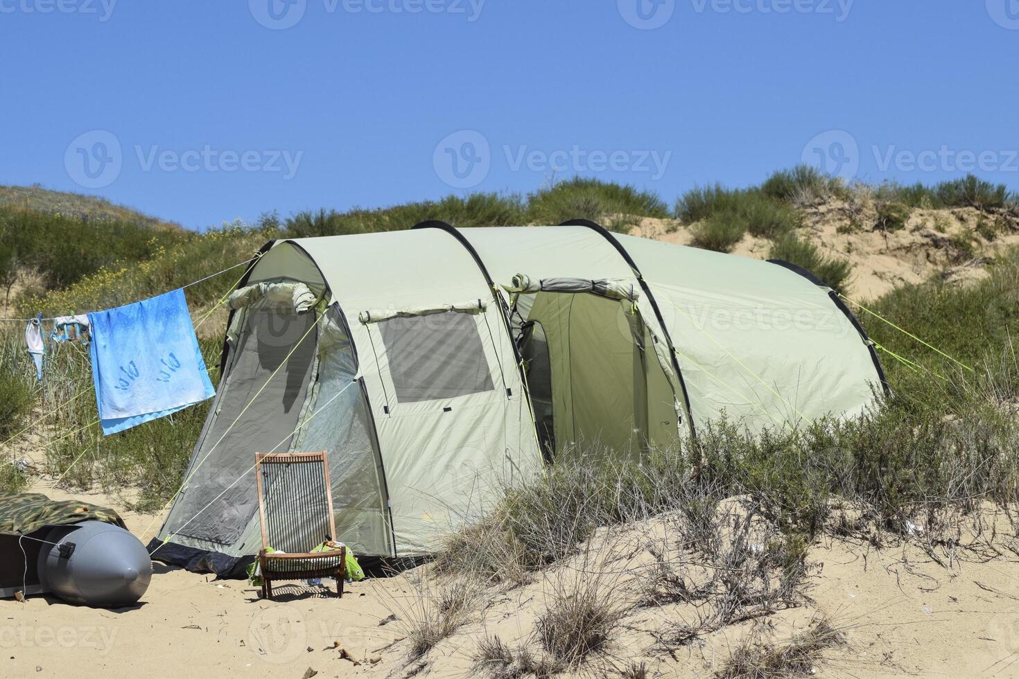 toerist vouwen tenten tussen kust- vegetatie. de tent is modern. foto