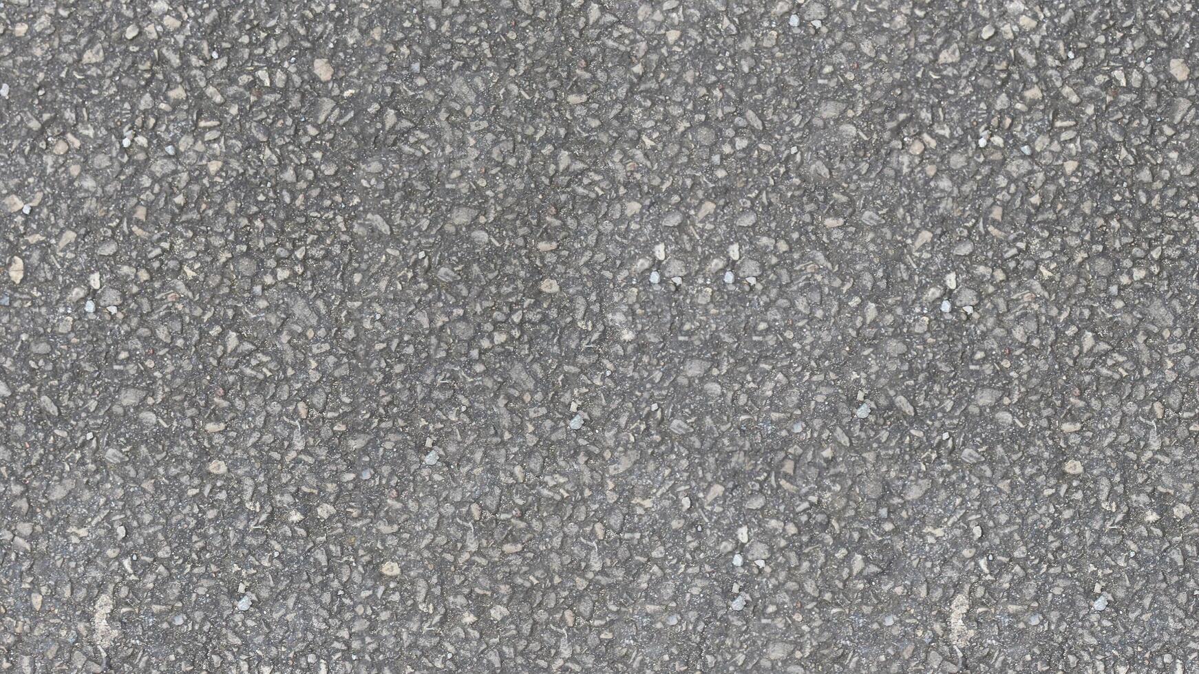 ai gegenereerd een uniform grijs asfalt structuur gemaakt omhoog van klein stenen en steentjes in variërend tinten van grijs Leuk vinden weg structuur achtergrond foto