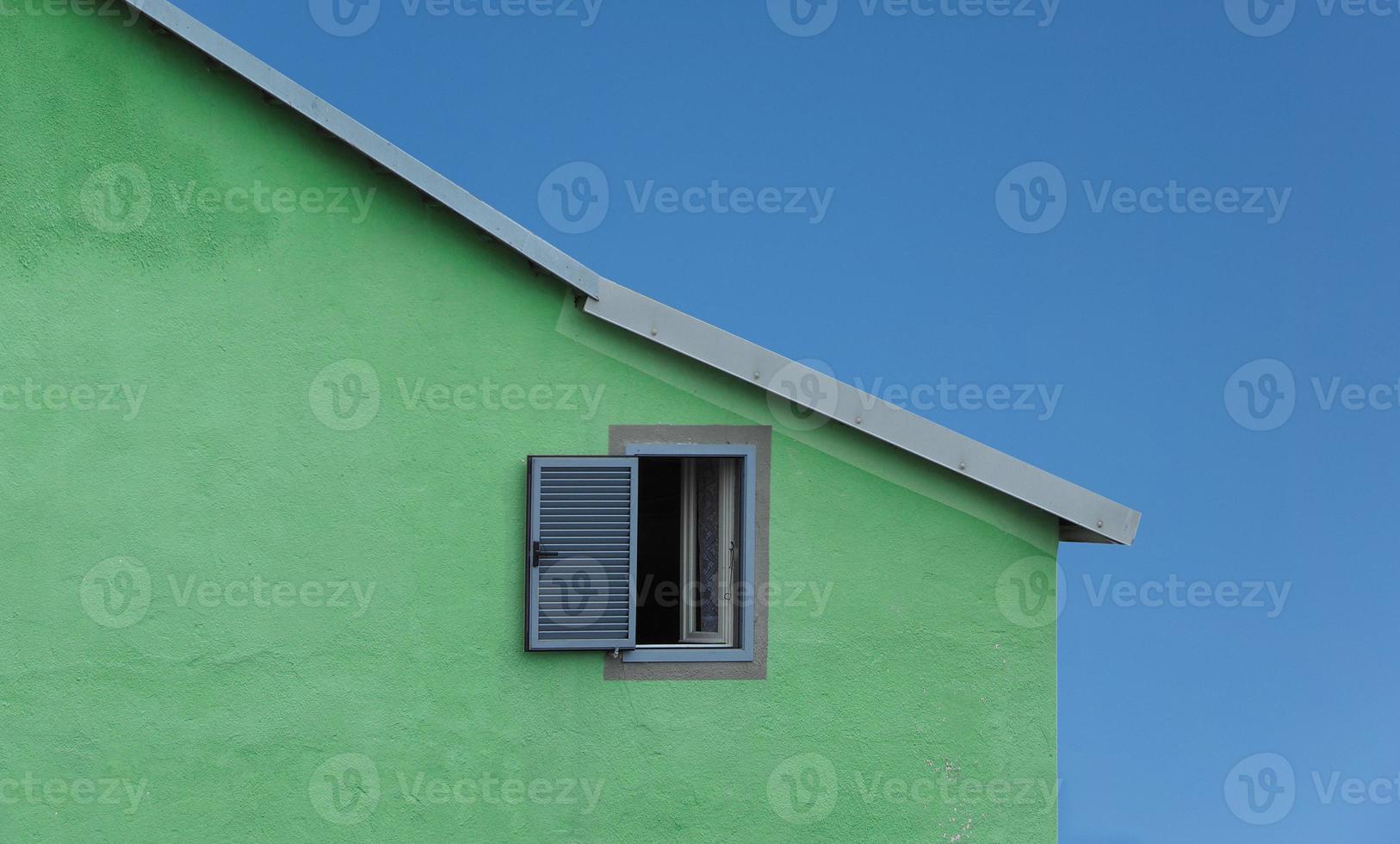 groen huis blauwe lucht foto