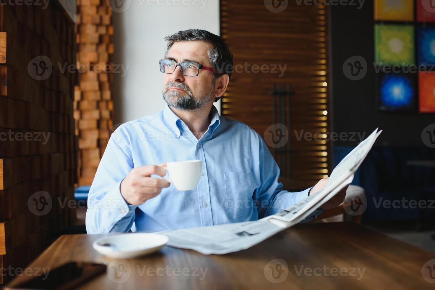 koffie pauze. Mens drinken koffie en lezing krant- in cafe bar foto