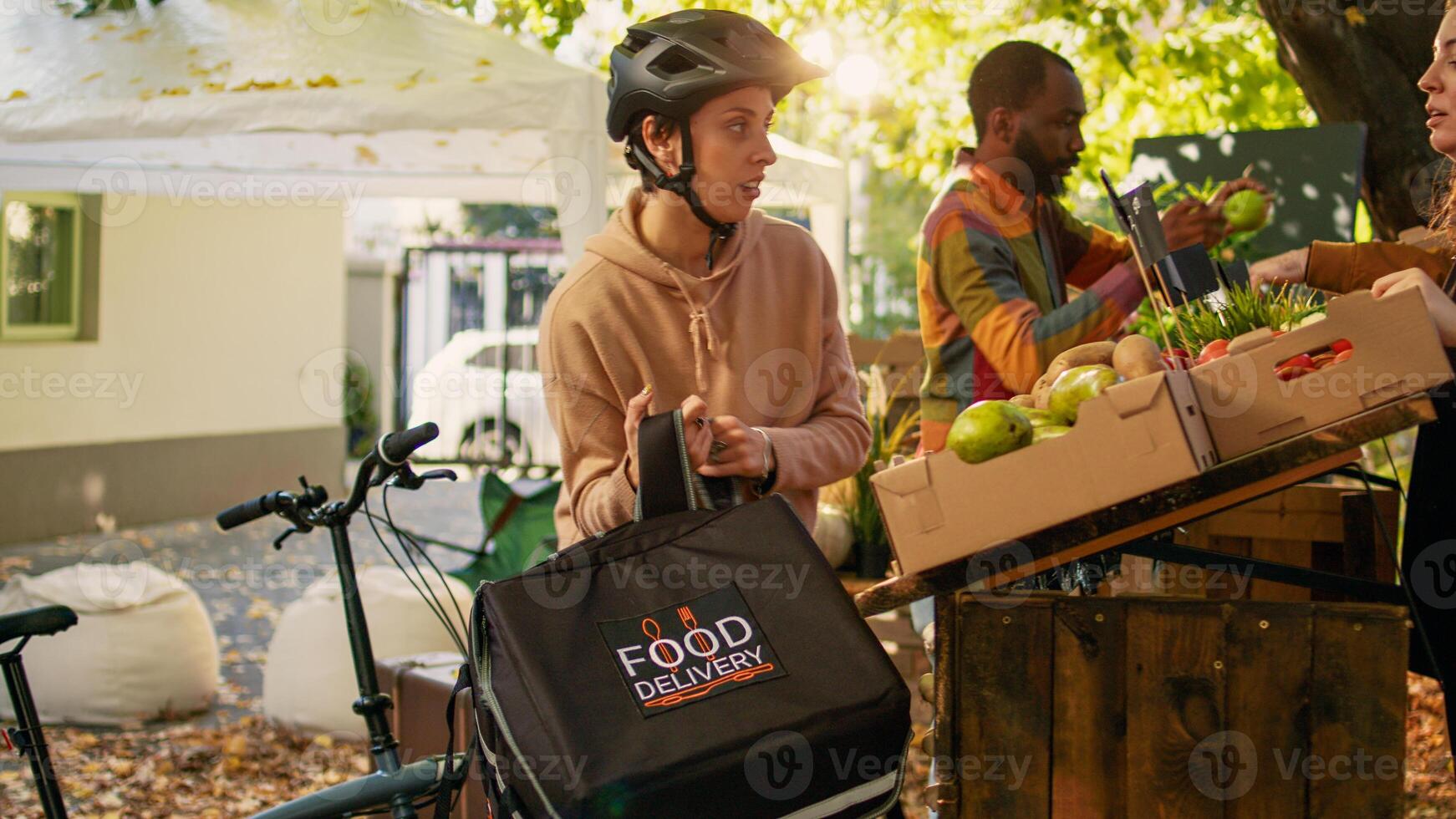 klein bedrijf eigenaar geven voedsel bestellen naar levering vrouw, werken Aan leveren biologisch vers produceren van tuin. vrouw boer pratend naar koerier Aan fiets, leveren gezond eco producten. foto