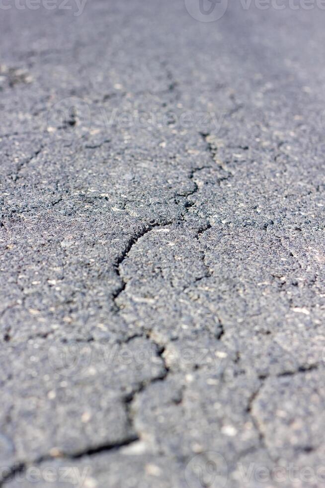 structuur van de grond, gebarsten asfalt textuur, gebarsten grond met scheuren foto