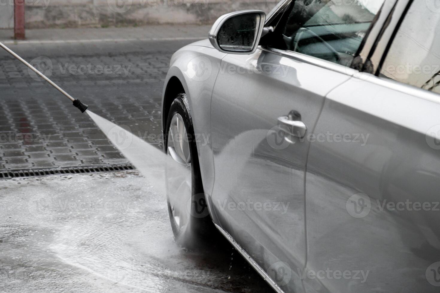 het wassen luxe zilver auto Aan contactloos auto wassen. het wassen sedan auto met schuim Zelfbediening en hoog druk water. schoonmaak de details van auto. netheid en bestellen in stedelijk milieu foto