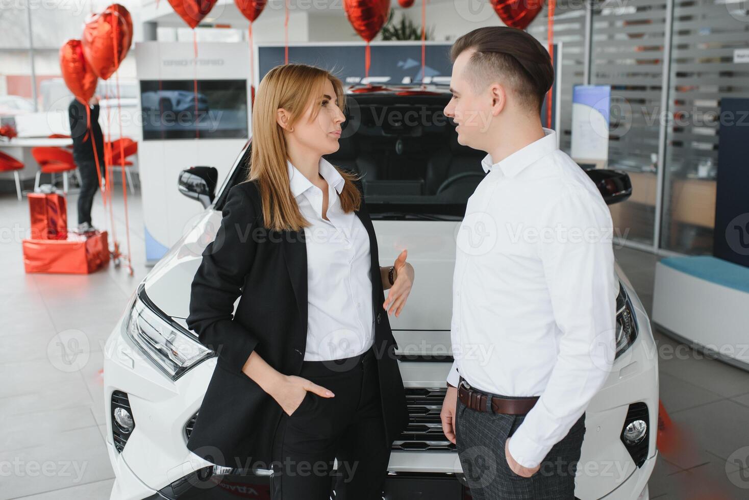 jong mooi gelukkig paar buying een auto. man buying auto voor zijn vrouw in een salon. auto boodschappen doen concept foto