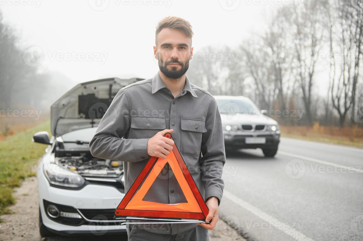 verdrietig Mens in de buurt gebroken auto zoeken helpen in veld- foto