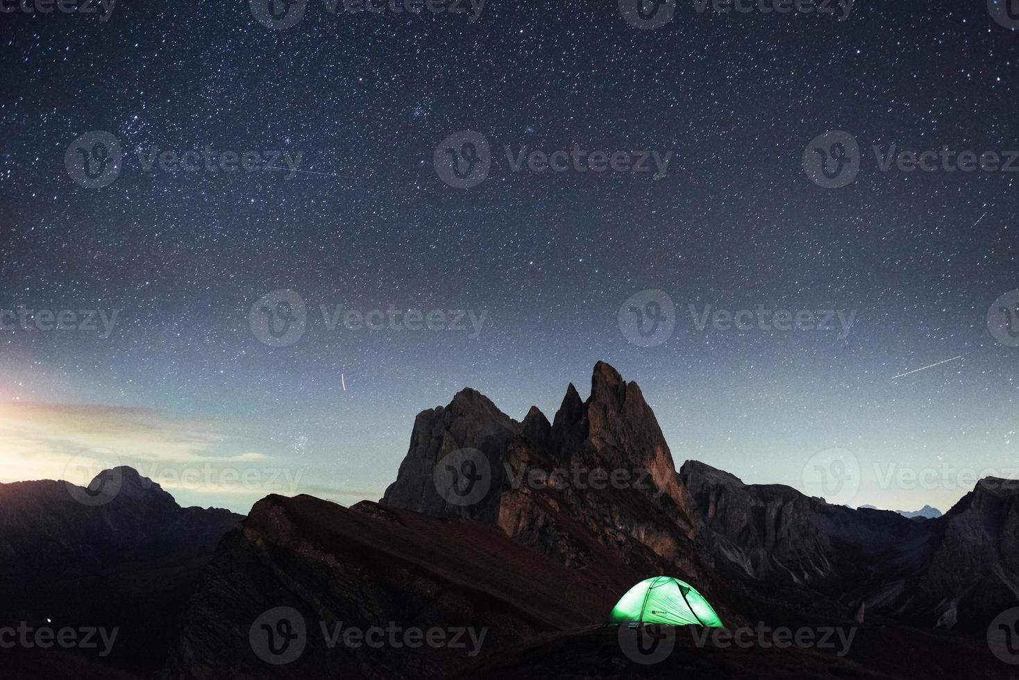 uitstekende plek. nacht foto van seceda dolomieten bergen. toeristen rusten in de groene tent