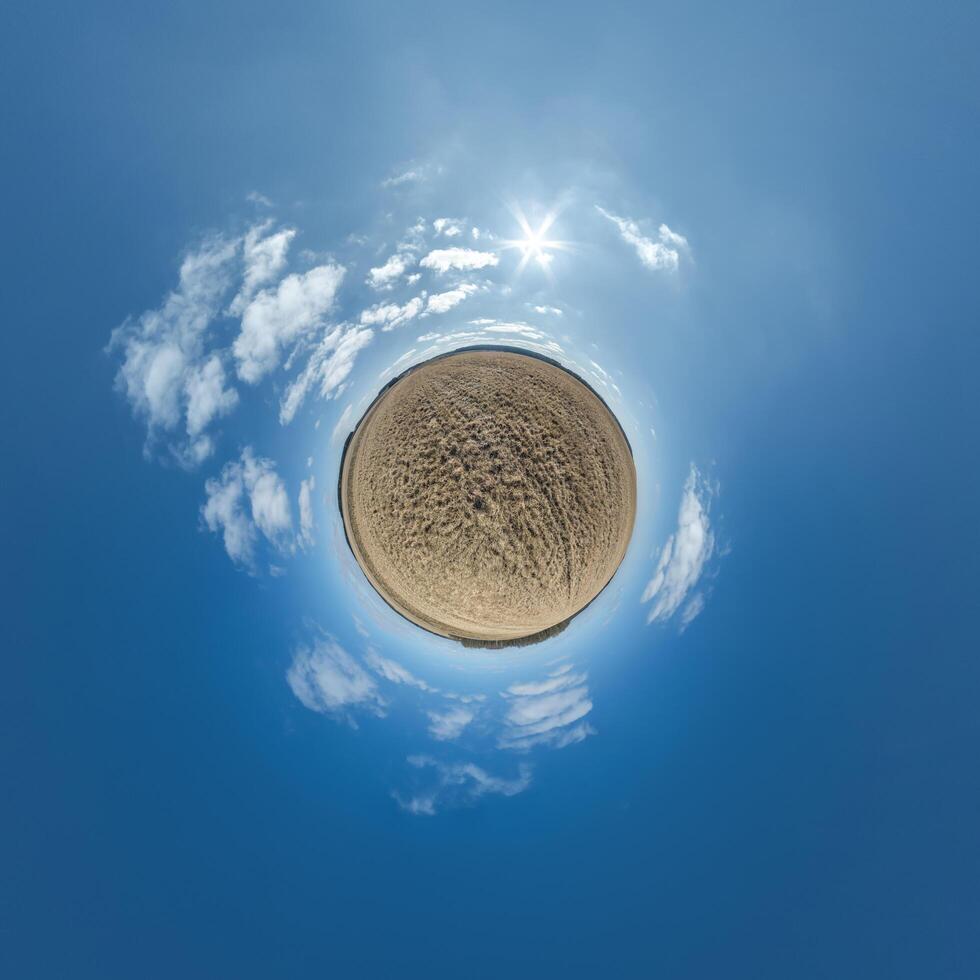 gemakkelijk klein planeet zonder gebouwen in blauw lucht met mooi wolken. transformatie van bolvormig panorama 360 graden. bolvormig abstract antenne visie. kromming van ruimte. foto