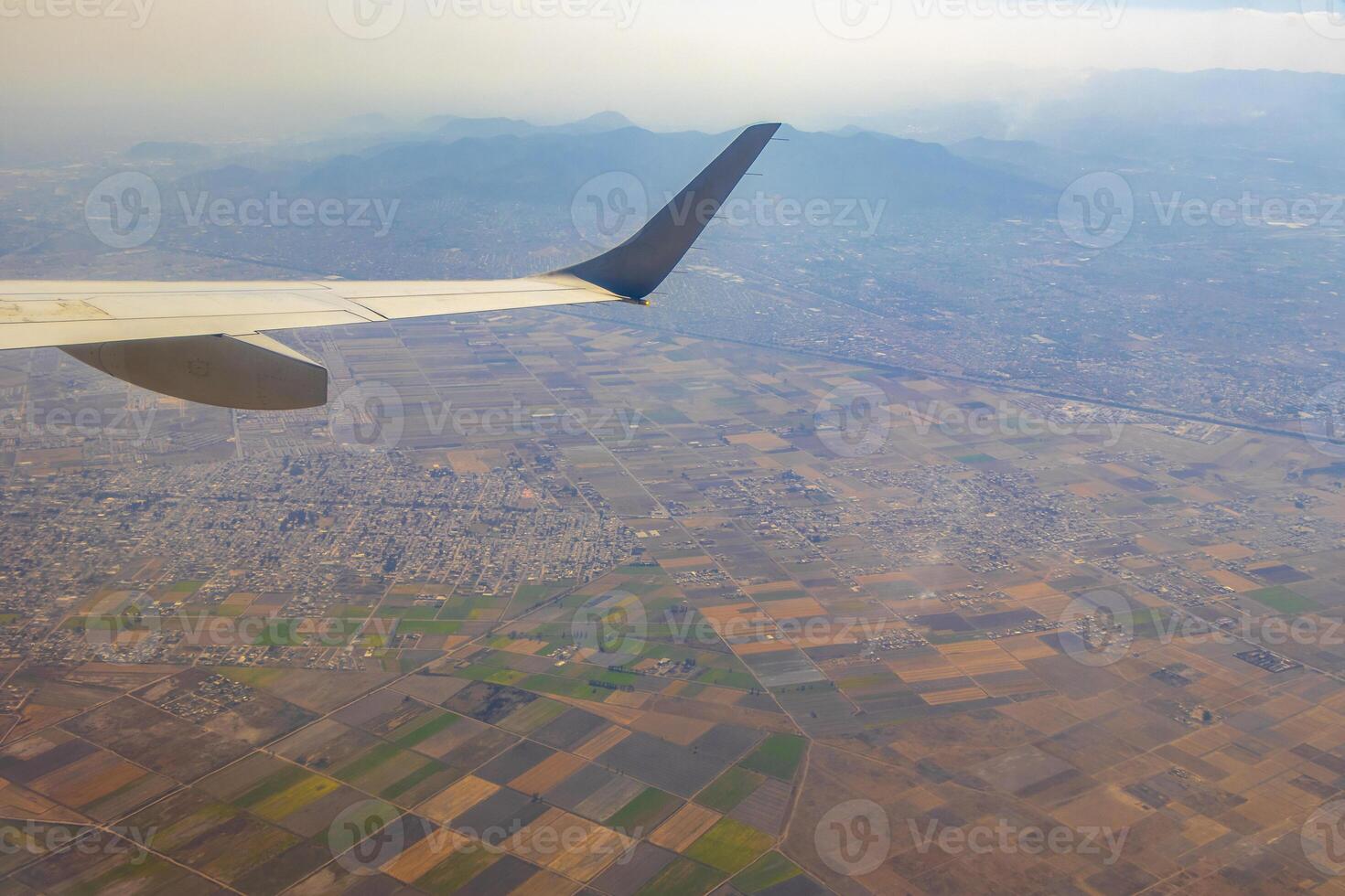 vliegend vliegtuig over- Mexico wolken lucht vulkanen bergen stad woestijn. foto