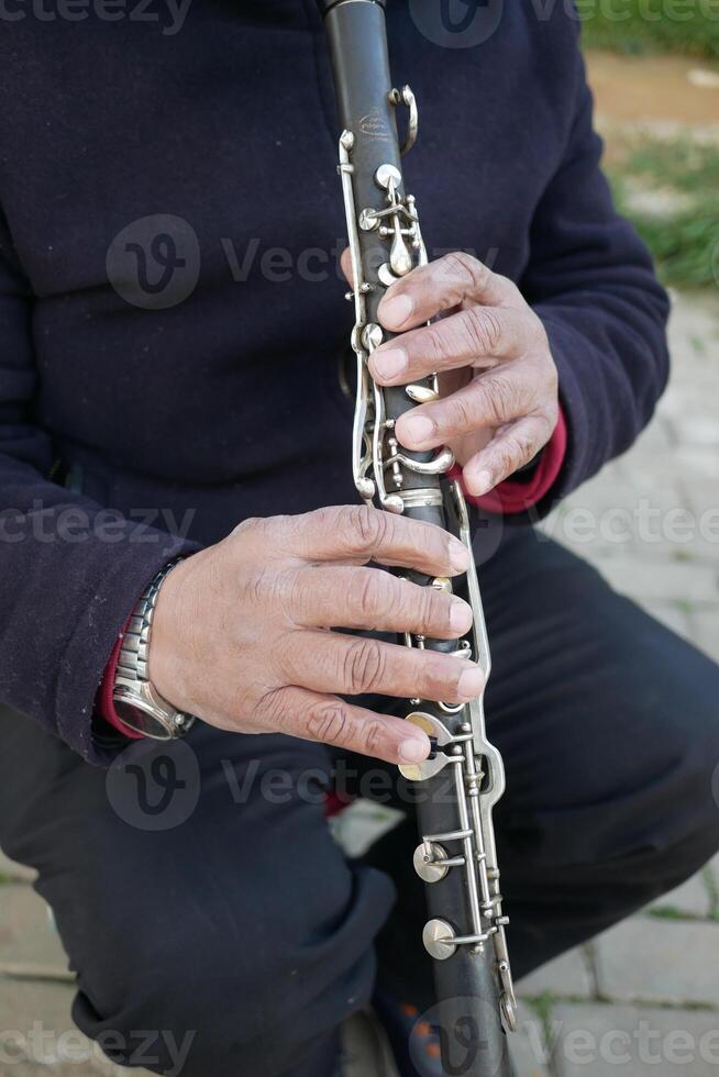 musicus spelen Aan klarinet Bij straat foto