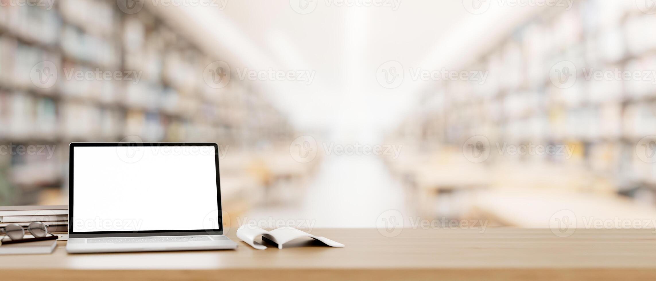 een laptop computer mockup en boeken Aan een houten tafel in een lezing kamer in een bibliotheek. foto