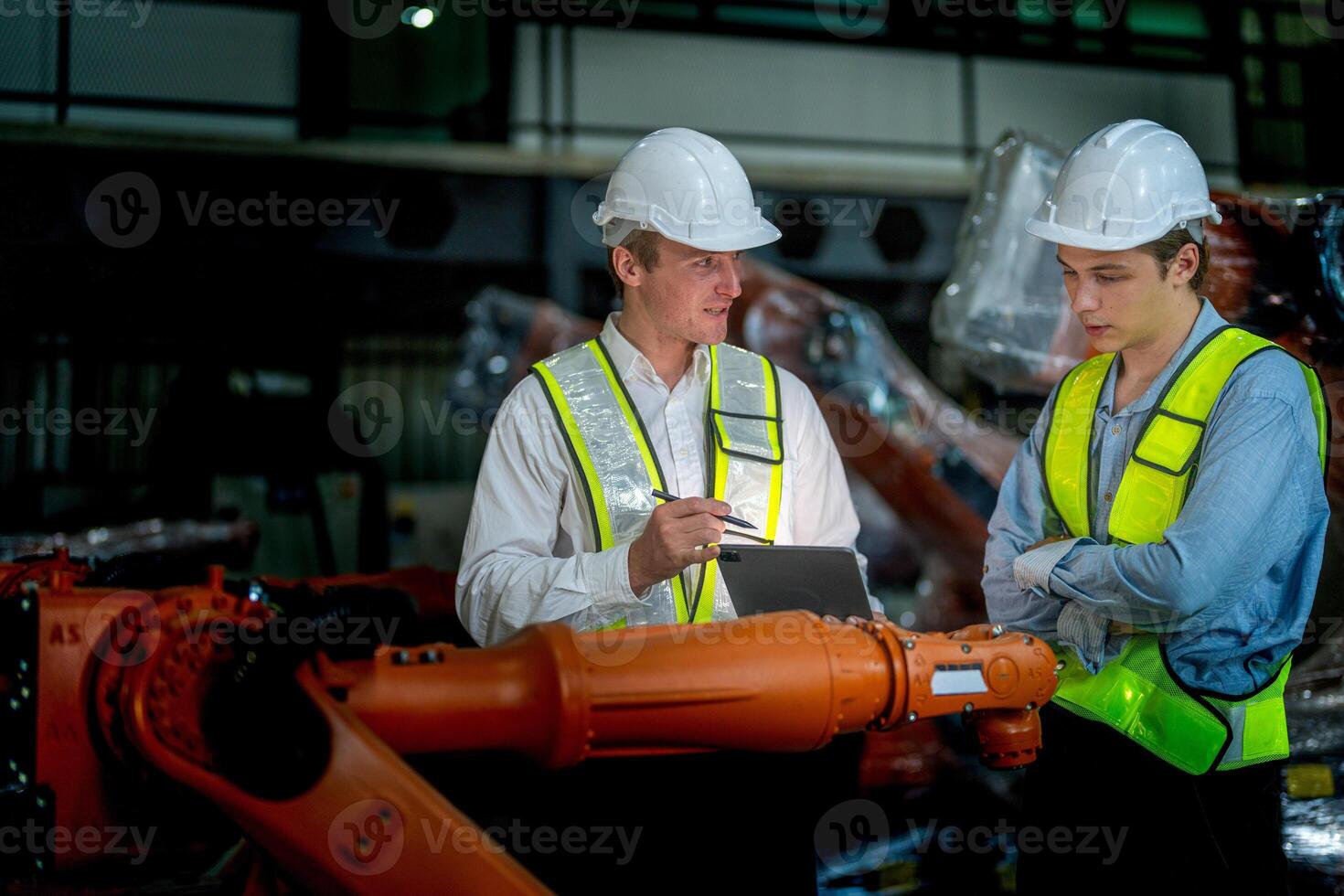 verkoop manager en fabriek eigenaar in pakken onderhandelen verkoop robots gebruikt in de fabriek. bedrijf ingenieurs vergadering en controle nieuw machine robot. arbeiders wandelen Bij magazijn lassen machine. foto