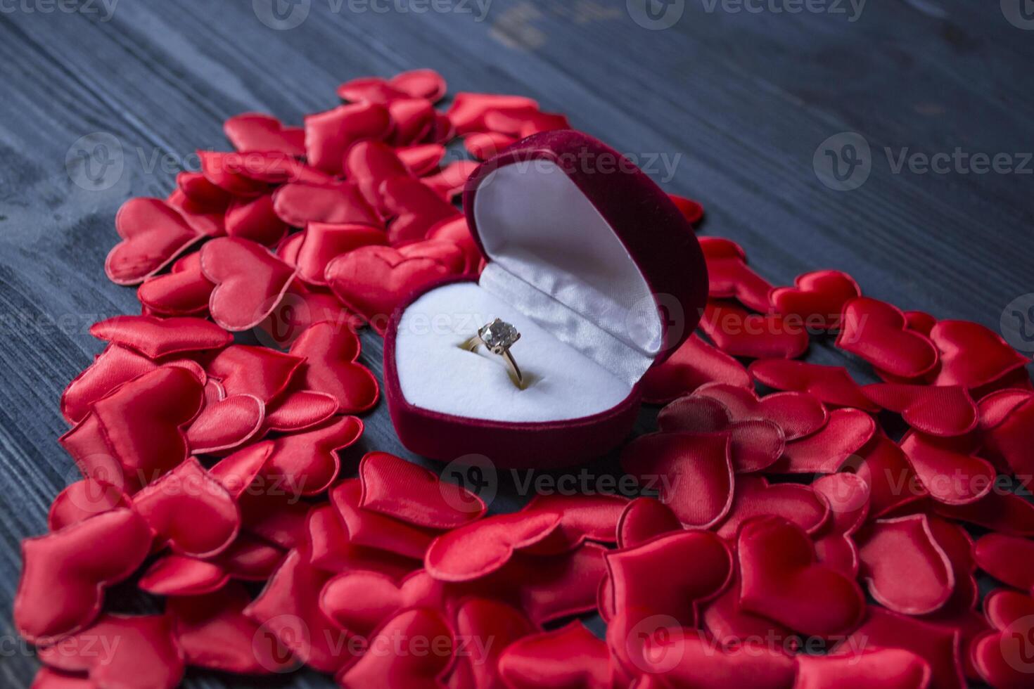 verloving ring in een rood doos Aan een liefde harten achtergrond. foto