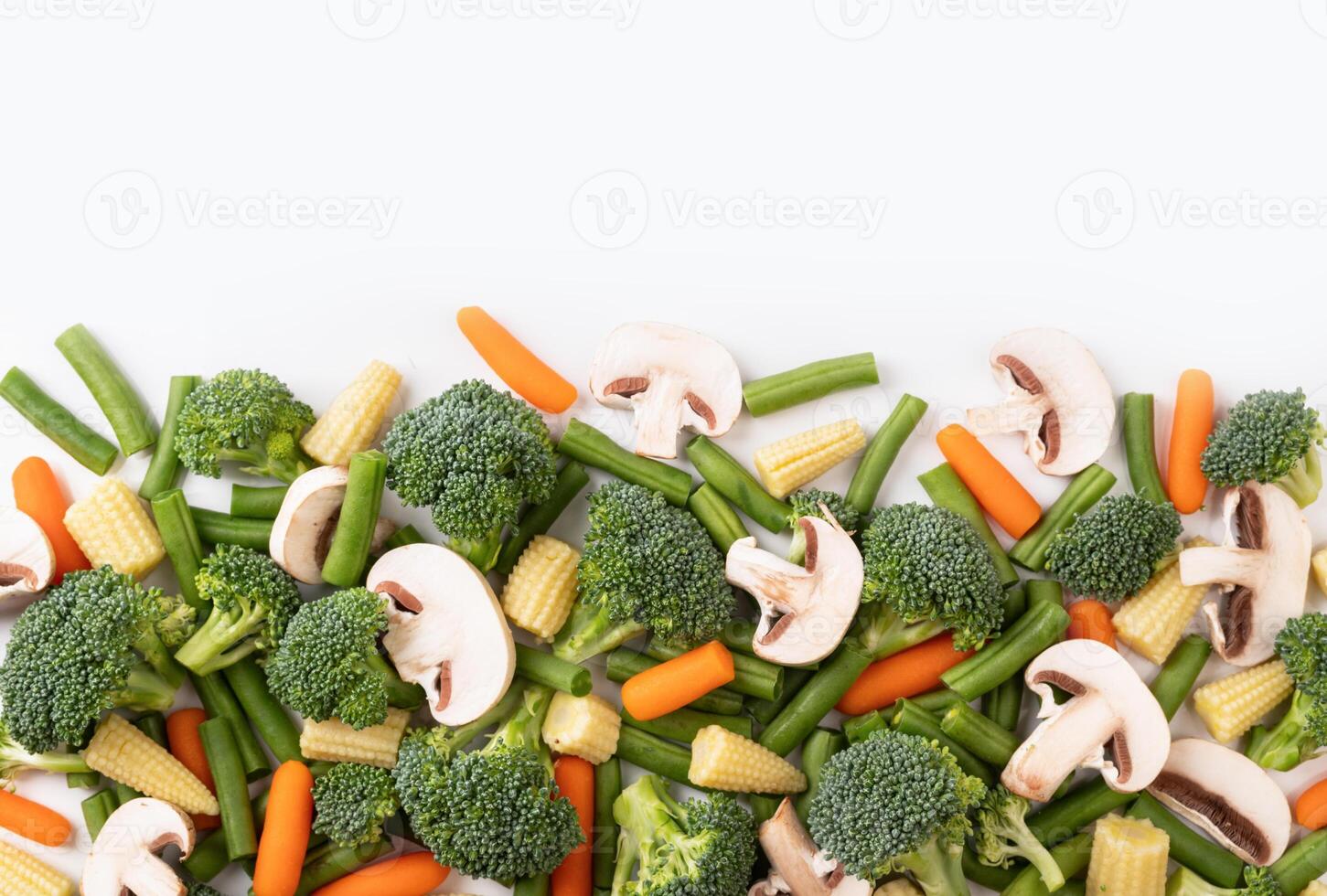 de mengen rauw groente. vlak leggen van vers rauw biologisch groenten Aan wit achtergrond - broccoli, wortel, paddestoelen, groen bonen, bloemkool, mini maïs foto